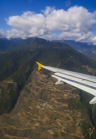 Flying over mountains and winding roads.
